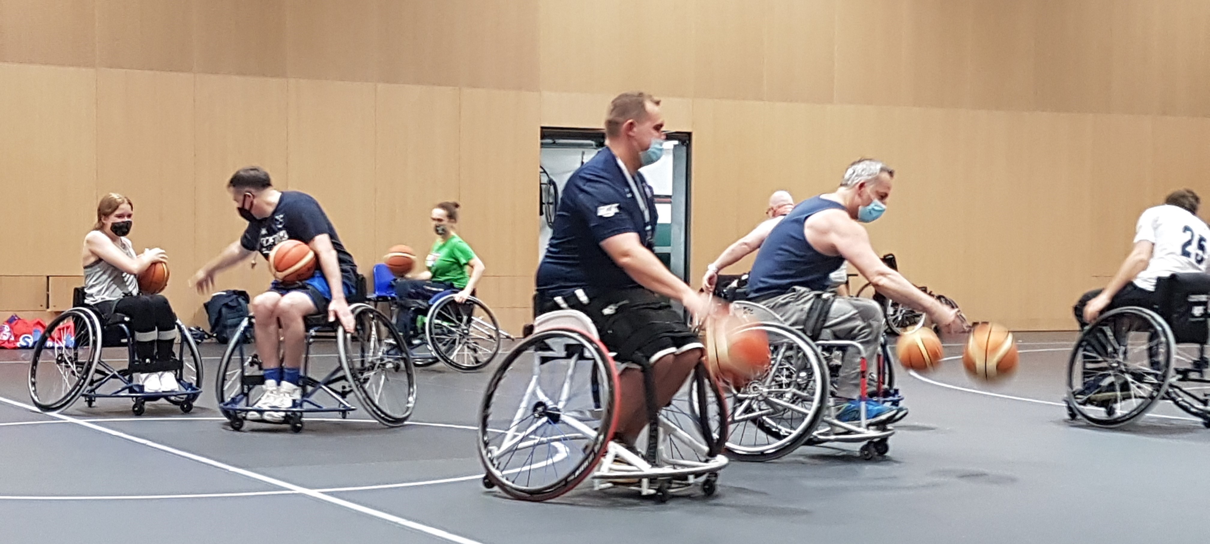 A photo of seven people playing Wheelchair basketball at Iffley Road Sports Centre