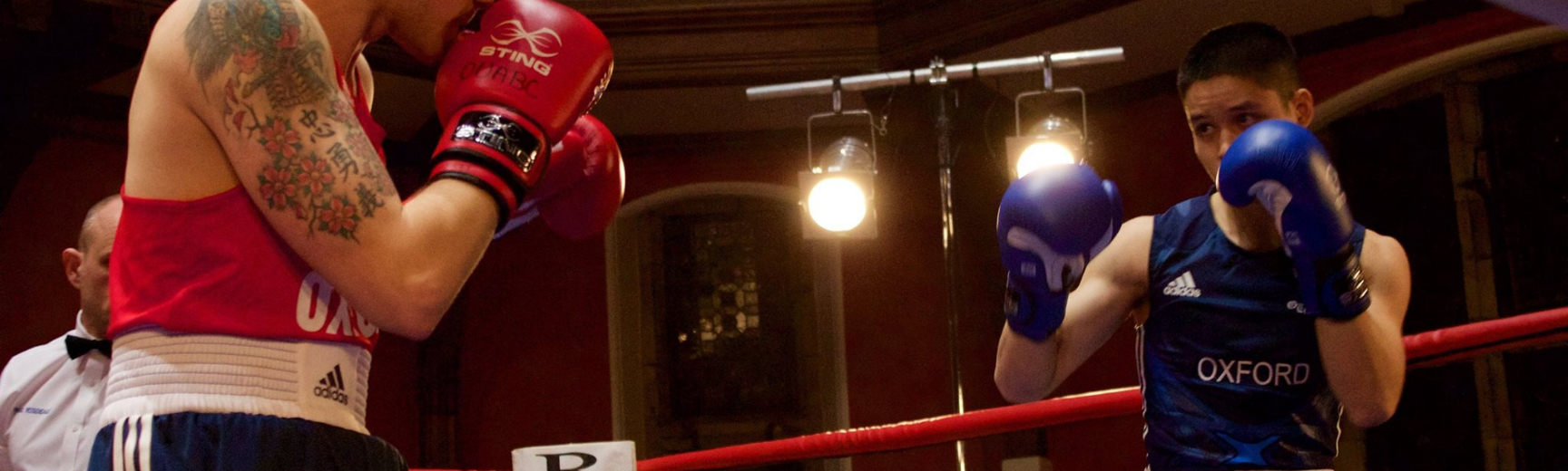 Two boxers competing in a boxing ring