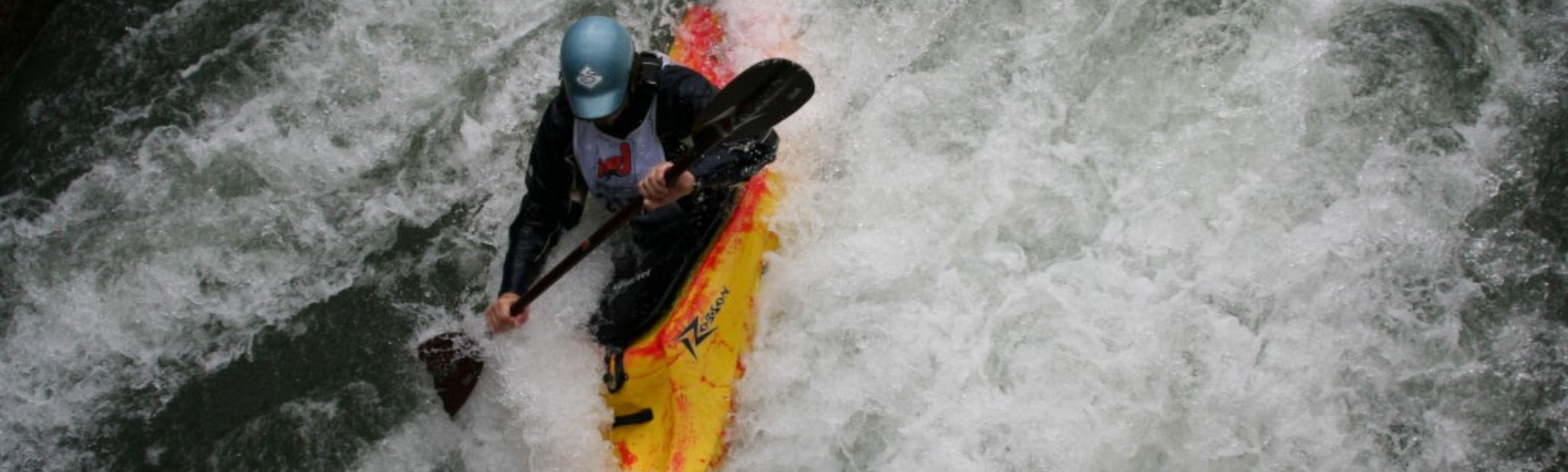 A kayaker tackling a steep white water decent