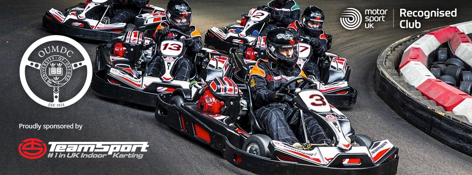 Several karts racing around a corner alongside the OU Motor Drivers Club logo