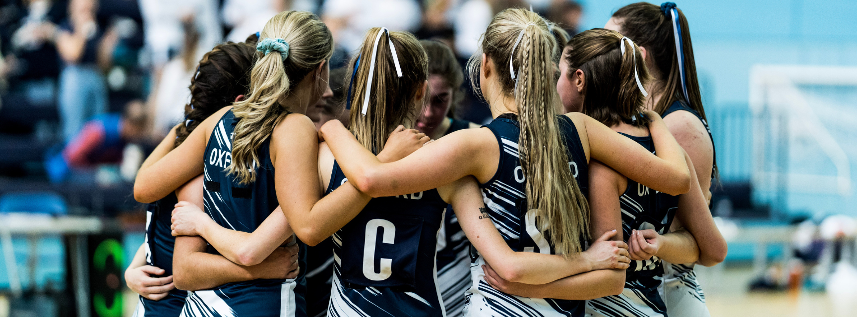 Oxford University Netball Club in a huddle before a match