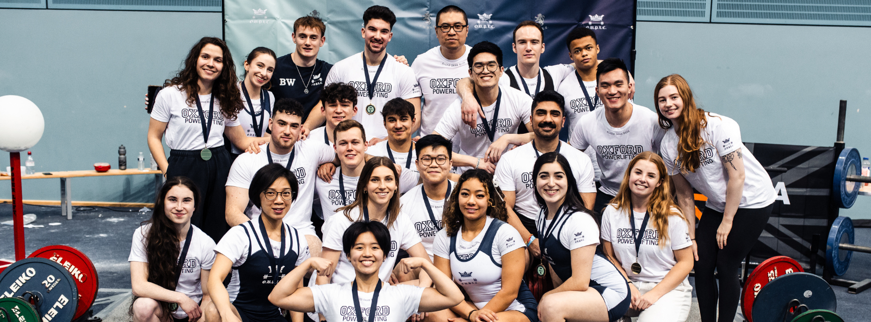 A group of powerlifters posing for a group photo after Varsity