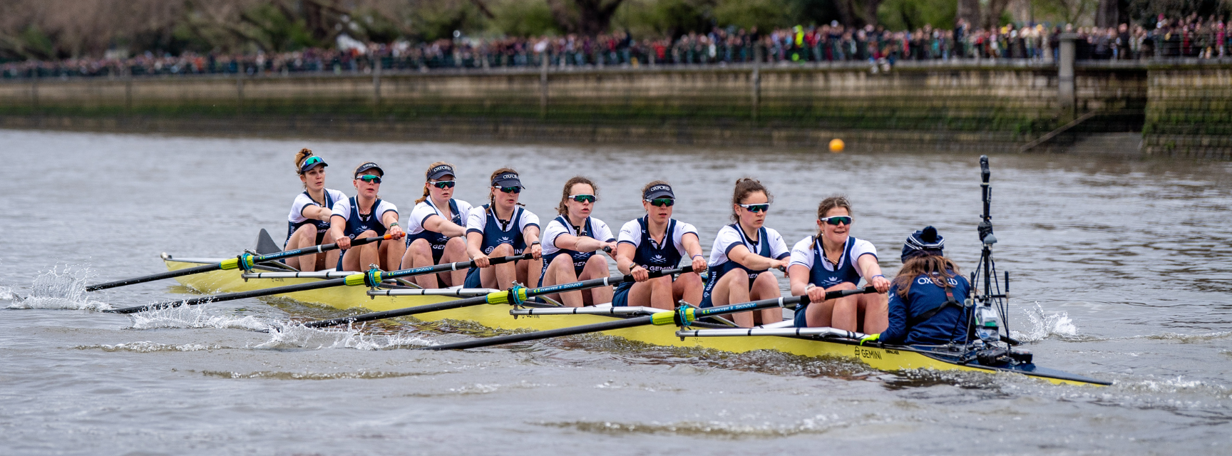 The women's blue boat racing down the Thames