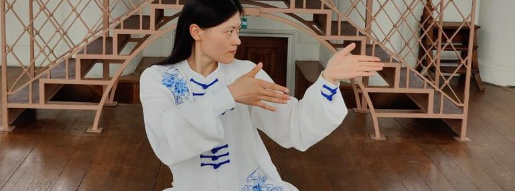 A women participating in Tai Chi in traditional attire