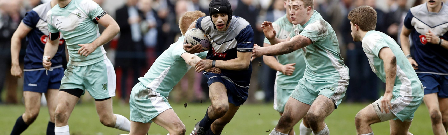 Several men playing rugby league in the Varsity match between Oxford and Cambridge