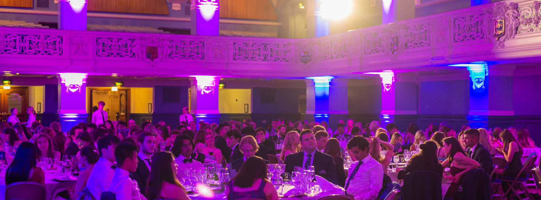 Website template Image of students sat at the tables at the Sports Ball