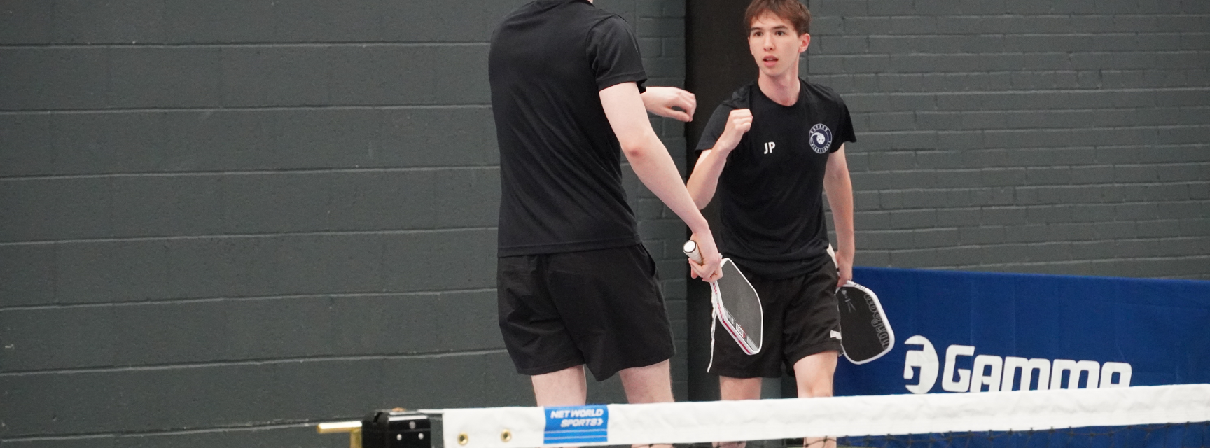 Two Oxford pickleball players celebrating a winning point