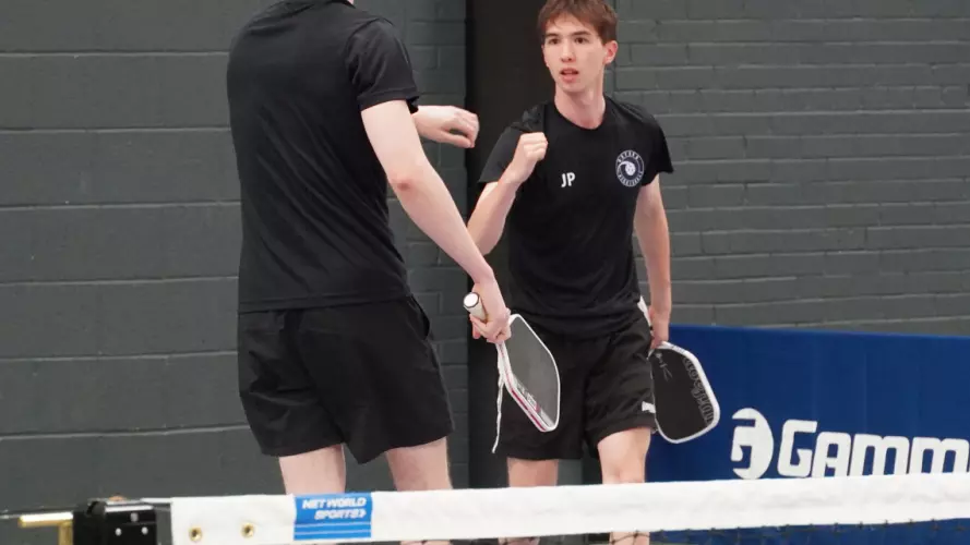Two Oxford pickleball players celebrating a winning point