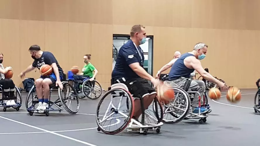 A photo of seven people playing Wheelchair basketball at Iffley Road Sports Centre