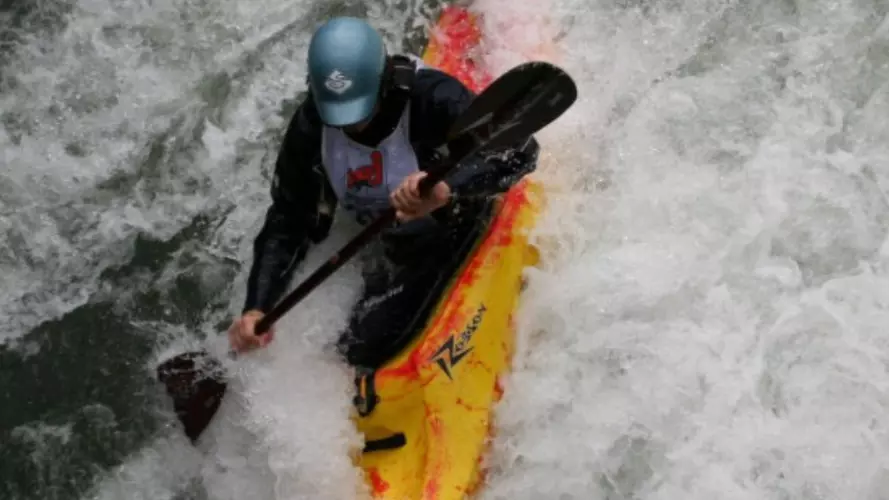 A kayaker tackling a steep white water decent