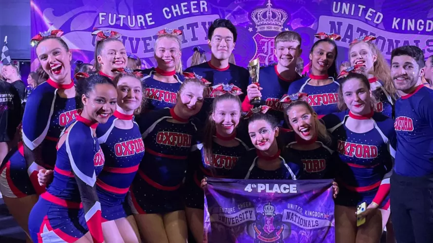 A squad of mixed cheerleaders celebrating 4th place at the national championships