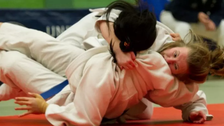 Two women on the floor during the Judo Varsity match between Oxford and Cambridge