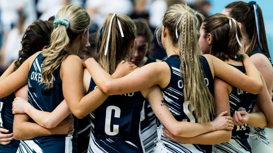 Oxford University Netball Club in a huddle before a match