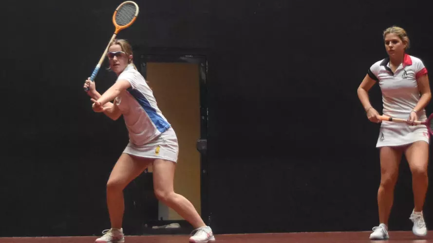 Two women playing Rackets against each other