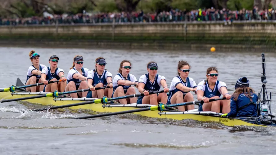 The women's blue boat racing down the Thames